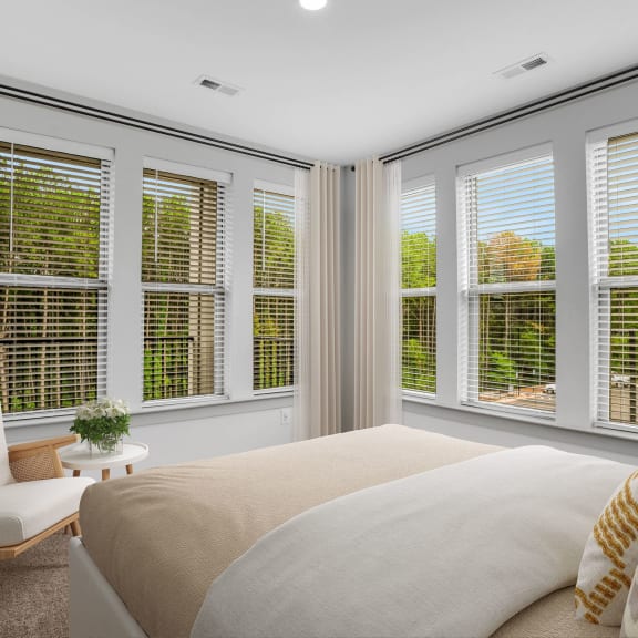 Thumbnail 9 of 9 a bedroom with a large bed and windows