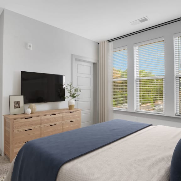 Thumbnail 7 of 9 a bedroom with a large bed and a tv