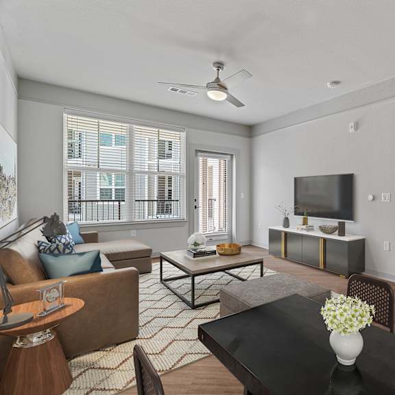A living room with a brown couch, a coffee table, and a television.