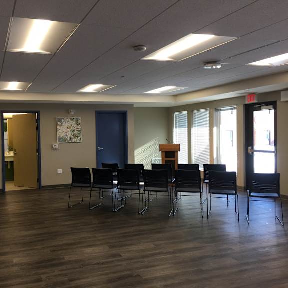 a room with a long table and chairs.