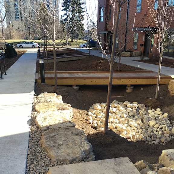 a wall with a stone and concrete base.