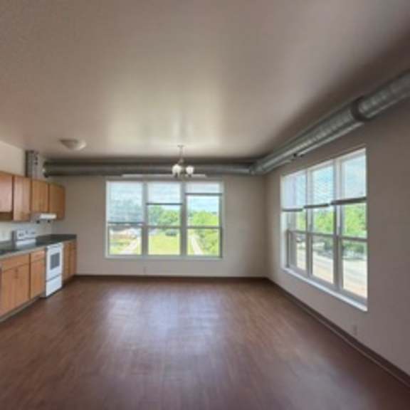 a kitchen with white appliances and wooden cabinets.
