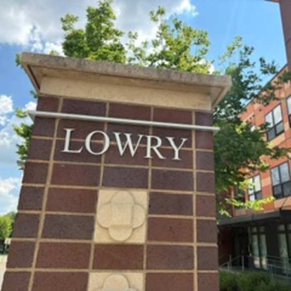 a brick pillar with the word lowry on it.