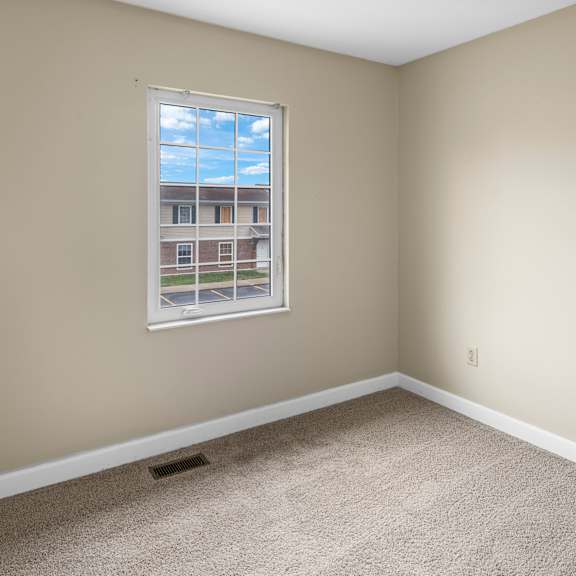 a room with a window showing a view of a building outside.