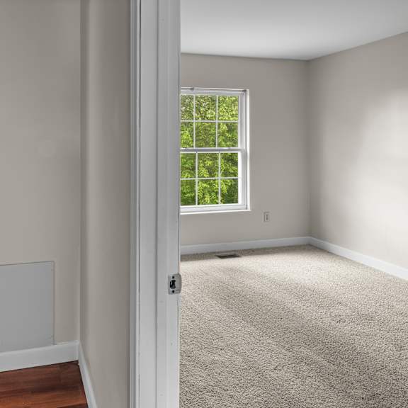 a room with a toilet and a window.