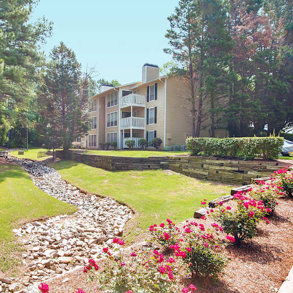 community with building, rock bed, flowers and woods at laurel oaks, north carolina