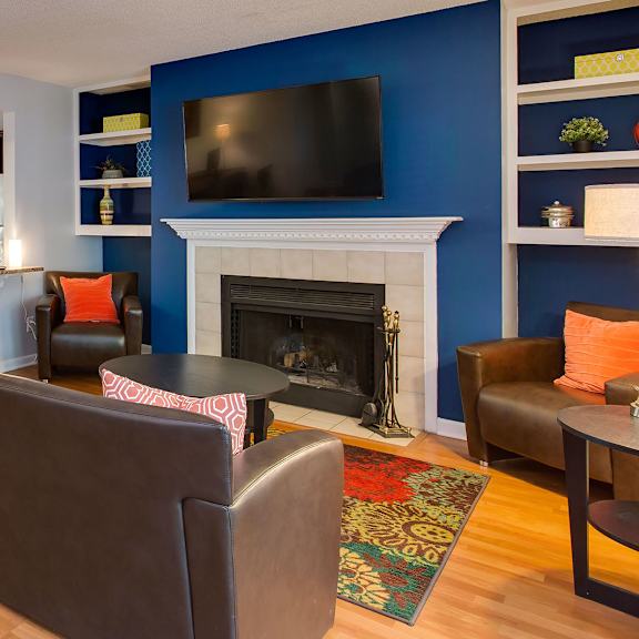 resident lounge with fireplace, seating and kitchen with coffee station at laurel oaks, raleigh, nc, 27613