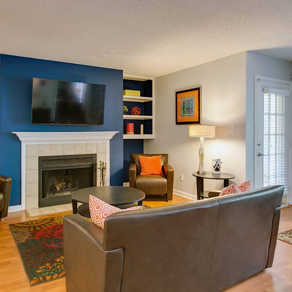 resident lounge with fireplace, seating, tv at laurel oaks, raleigh, north carolina