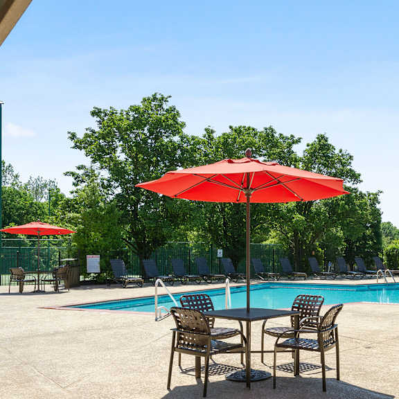 table and chair seating at pool at madison rockwood, ballwin, missouri