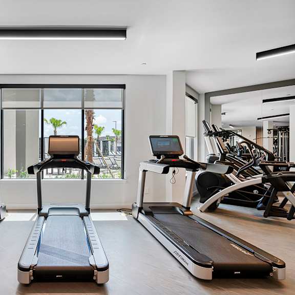 the gym is equipped with treadmills and other exercise equipment at madison waterford lakes, orlando, fl, 32826