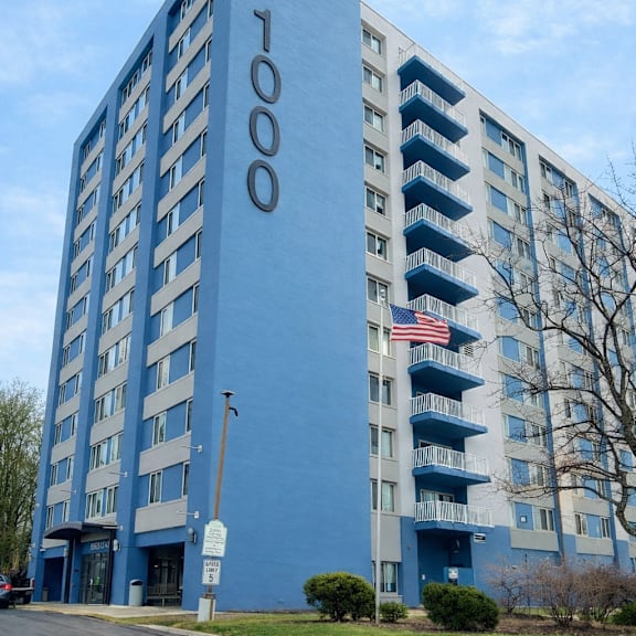 a tall blue building with the number 1000 on it.