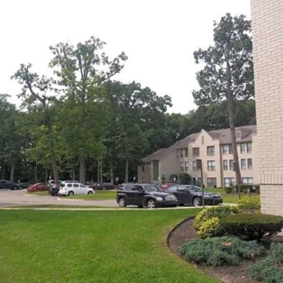 a parking lot with cars and a building in the background.