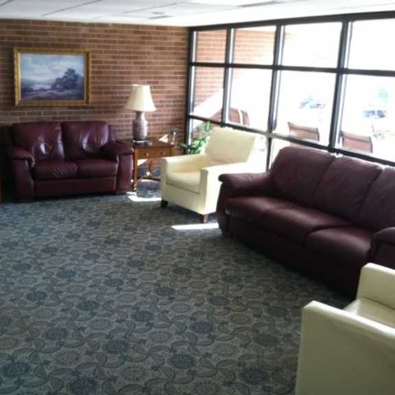 a living room with a red couch and a white couch.