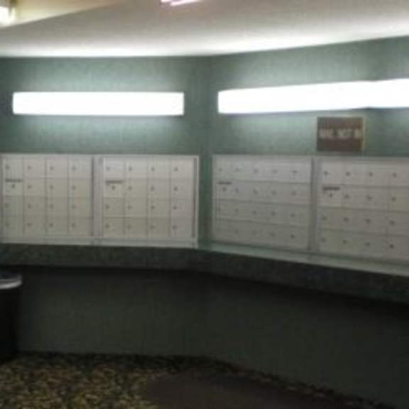 a wall of whiteboards in a room with a green wall.