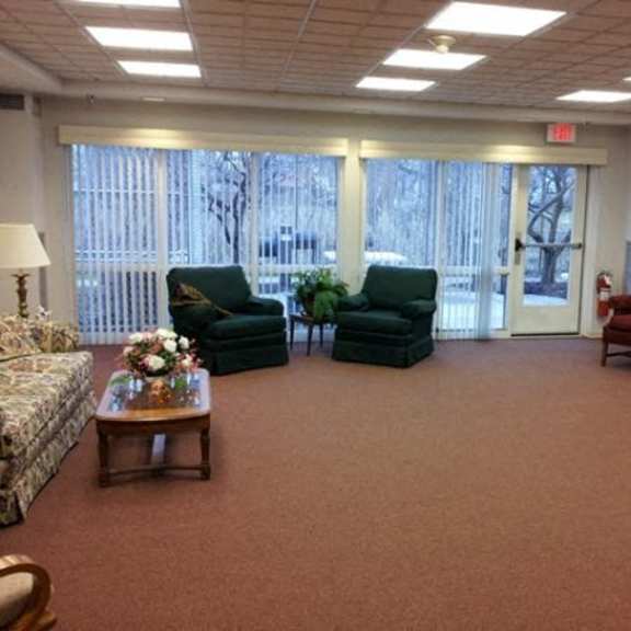 a waiting room with a couch, chairs, and a coffee table.