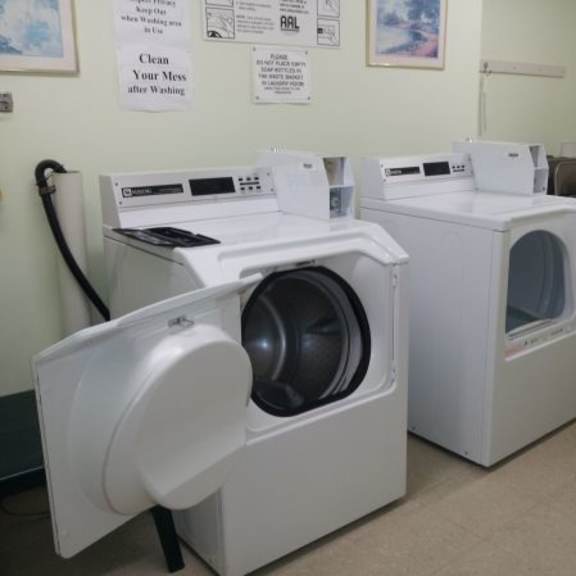 two front loading washing machines in a laundromat.