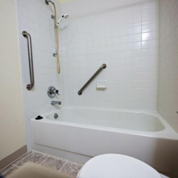 a white bathroom with a tub, toilet and sink.