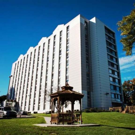 a tall white building with a gazebo in front of it.