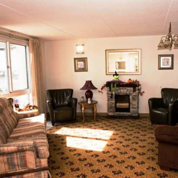 a living room with a fireplace and a chair.