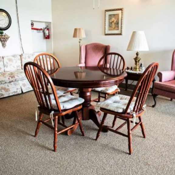 a set of chairs and a table are in a room.