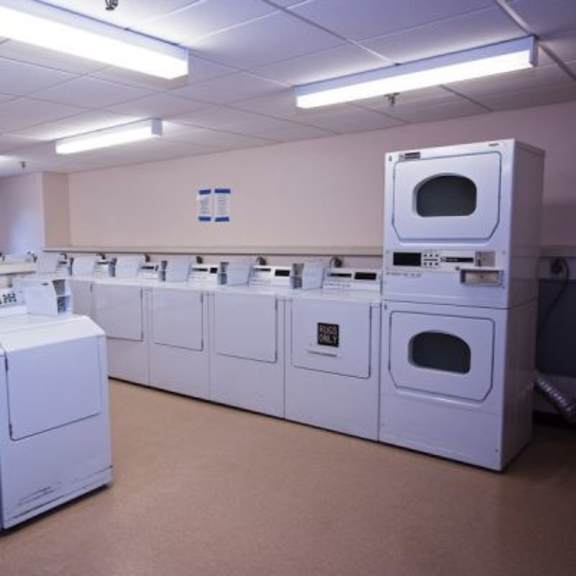 a laundry room with washing machines and a dryer.