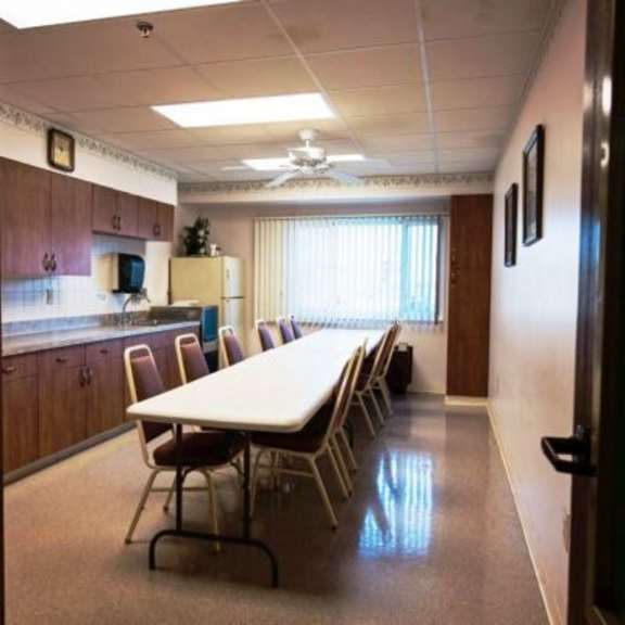 a conference room with a long table and chairs.