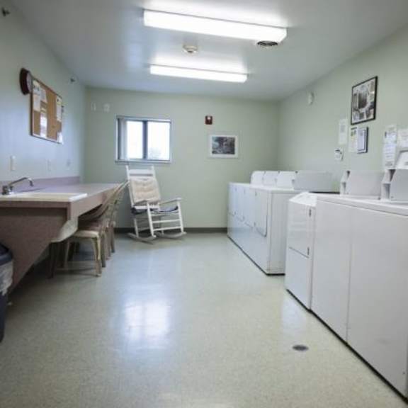 a laundry room with washers and dryers.