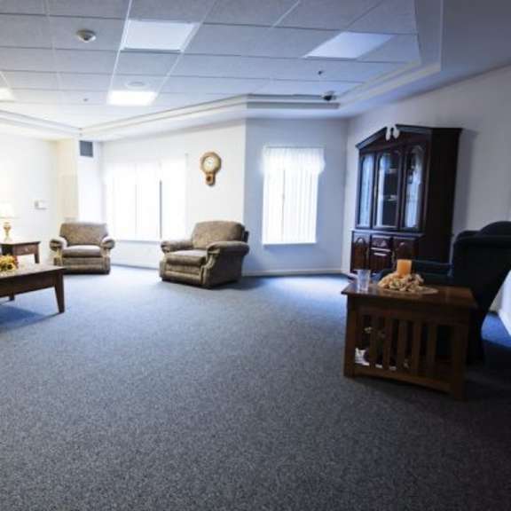 a living room with a sofa, armchairs, and a coffee table.