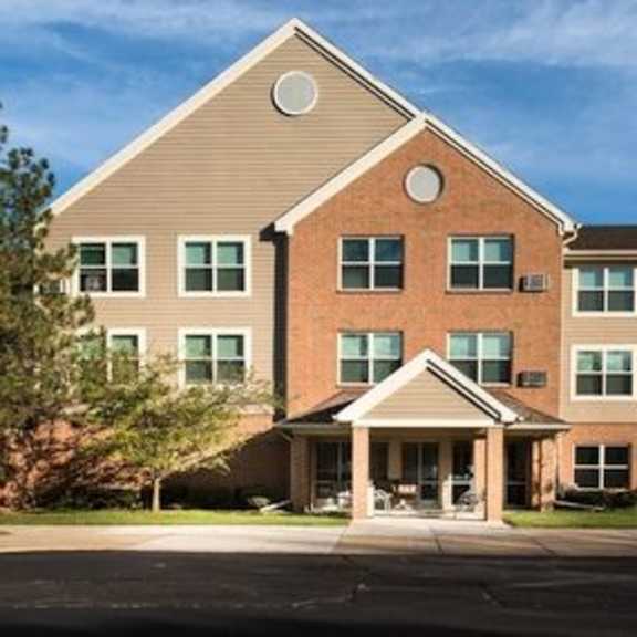 a two-story building with a covered patio area.