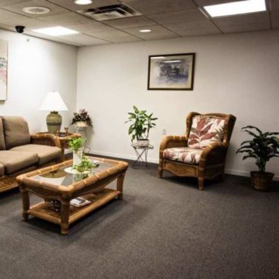 a living room with a couch, chair, and coffee table.