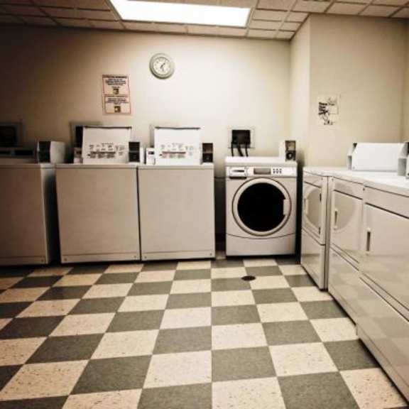 a laundry room with washers and dryers.