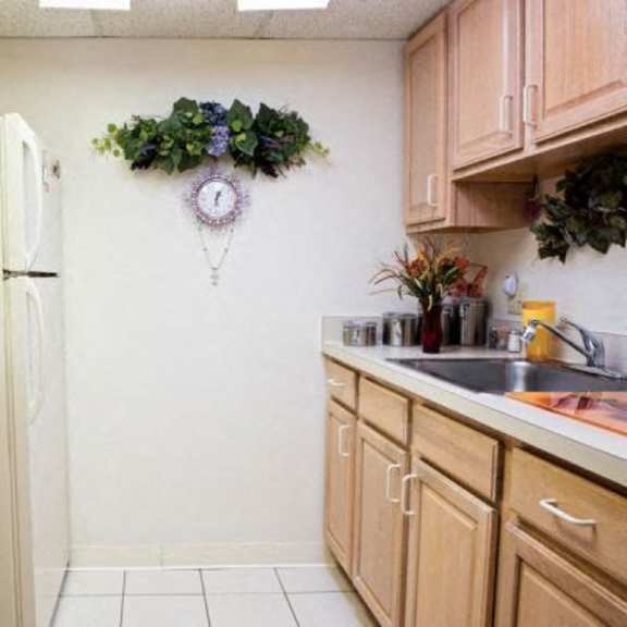 a kitchen with wooden cabinets and a white refrigerator.