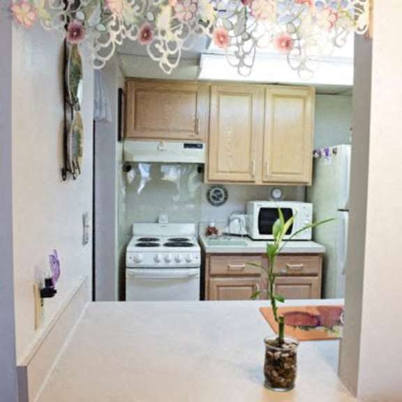 a kitchen with a white stove and cabinets.