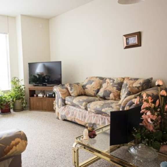 a living room with a couch, a coffee table, and a television.