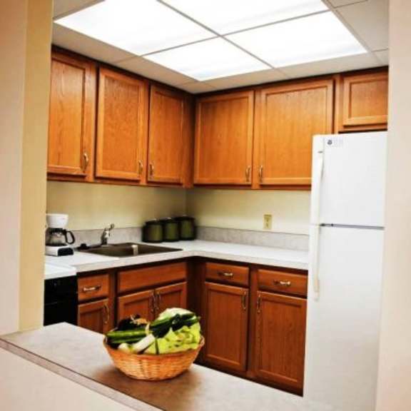 a kitchen with wooden cabinets and a white refrigerator.
