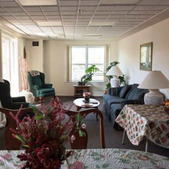 a living room with a couch, chair, and table.