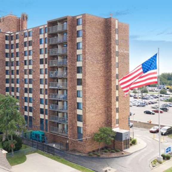 a large brick building with an american flag on top.