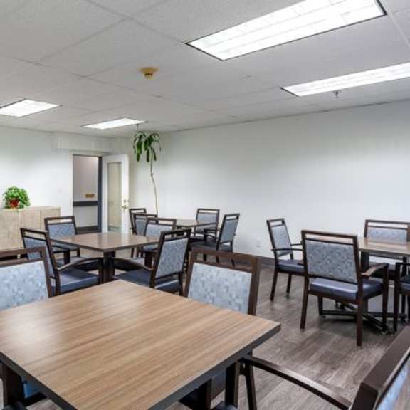 a conference room with a long table surrounded by chairs.