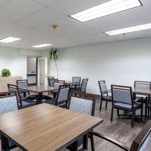 a conference room with a long table surrounded by chairs.