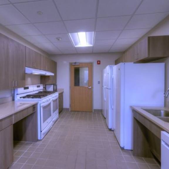 a kitchen with white appliances and wooden cabinets.