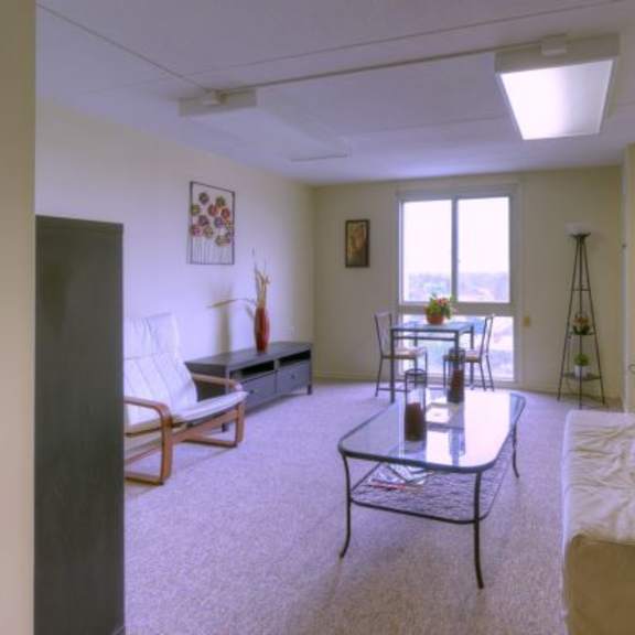 a living room with a couch, chair, and table.