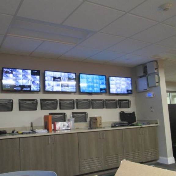 a wall of monitors in a room.