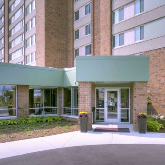 a building with a green awning and a glass door.