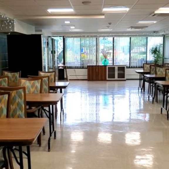 a library with tables and chairs and bookshelves.