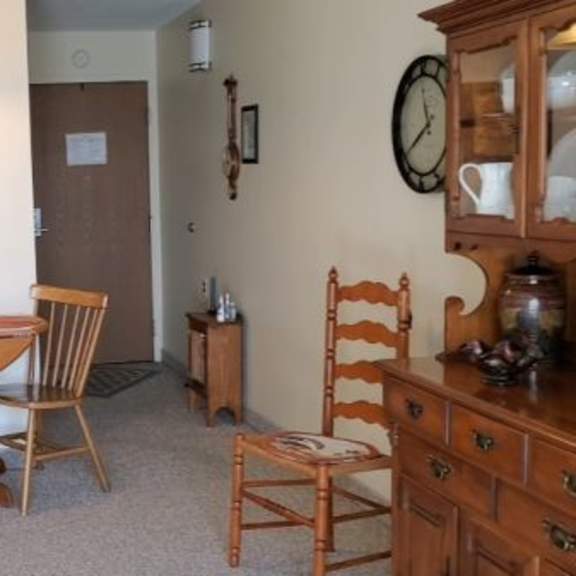 a dining room with a table and chairs.