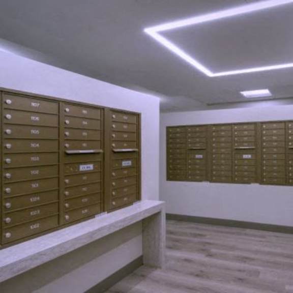 a room with a row of mailboxes on the wall.