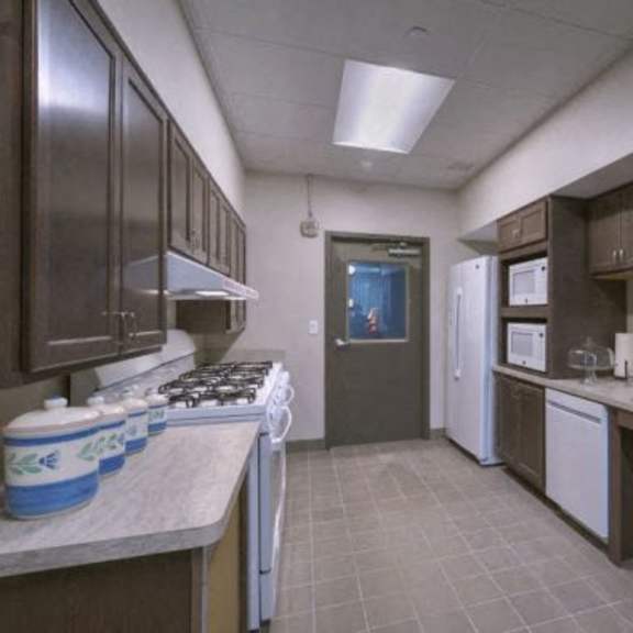 a kitchen with brown cabinets and a white refrigerator.