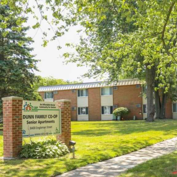 a brick building with a sign that says dunn family co-op senior apartments.