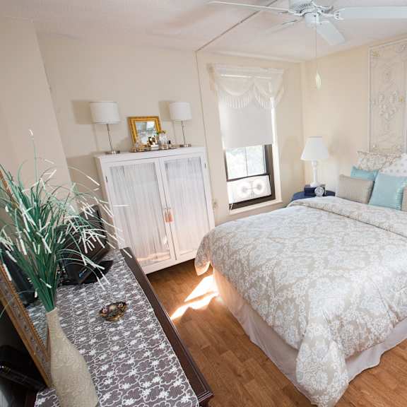 a bedroom with a large bed and a ceiling fan.