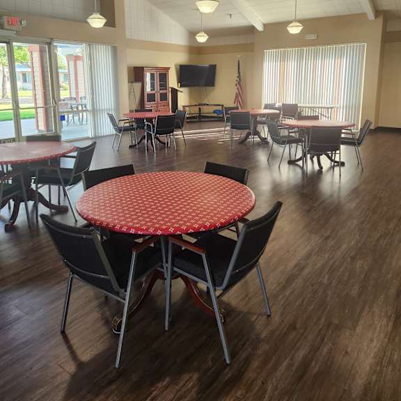 a view of a restaurant with a table and chairs.